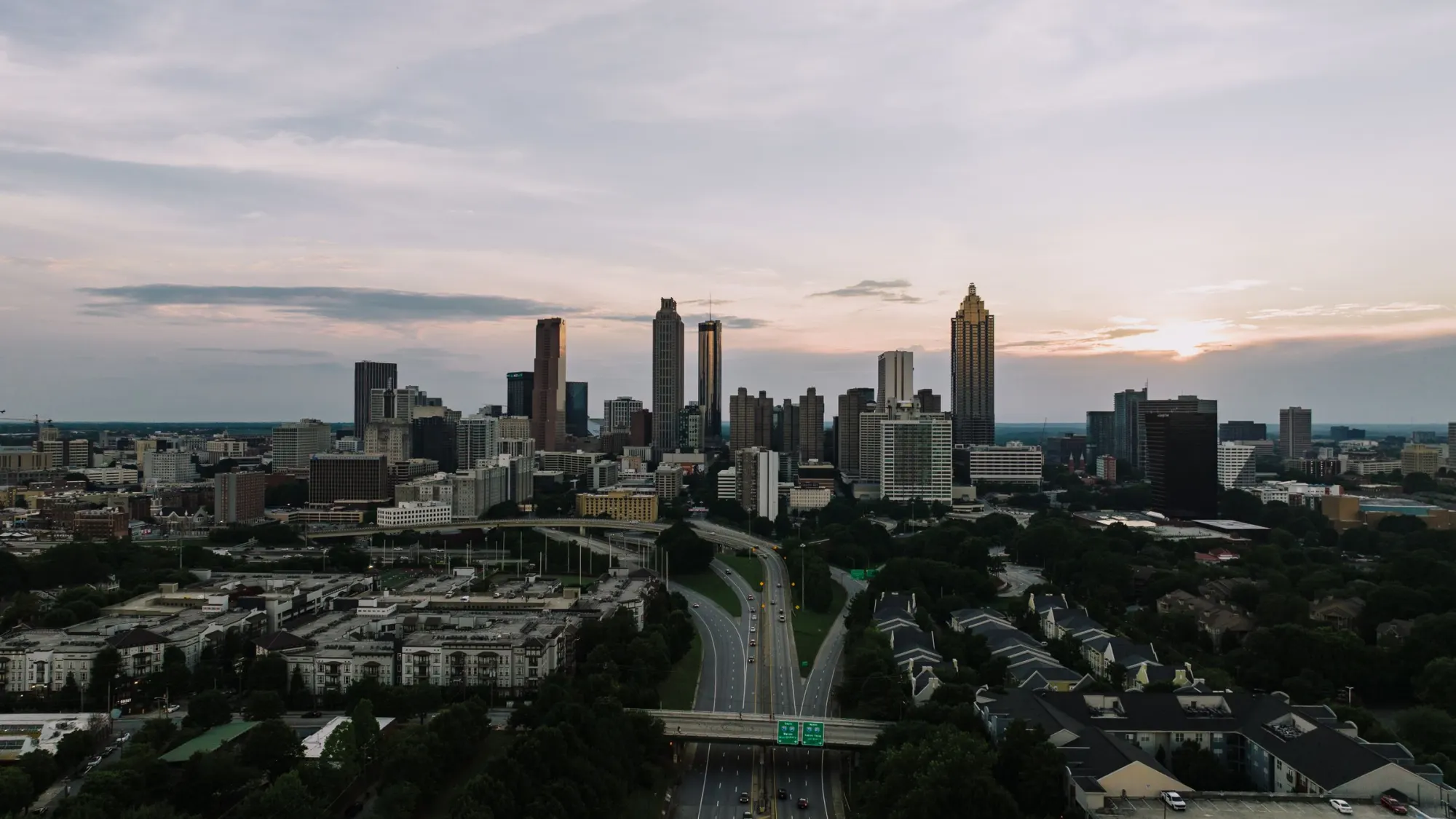 The city skyline at dusk, seen from a distance.